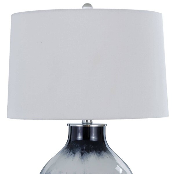 White shade and glass finial of a glass lamp